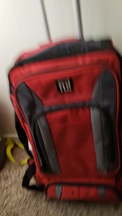 Red rolling suitcase