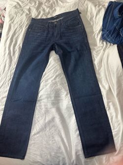 dark wash Hudson Los Angeles straight-leg jeans with a black leather branding patch.