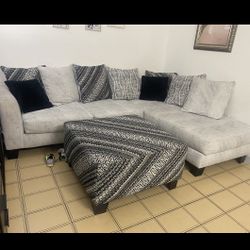 Light Grey And Black Sectional With Ottoman