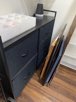 A modern fabric storage dresser with black drawers/ 0rganizers
