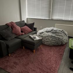 Bundle: Sofa with foot stool and pillows, bean bag chair, and rug