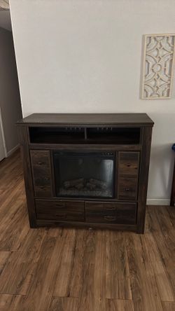 Dresser with electric fire place.