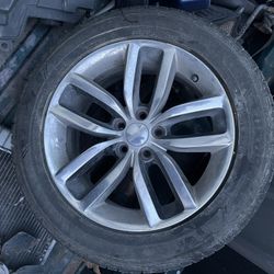 One dodge rim and 3 caps 