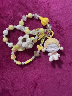 Popmart Skullpanda "The Warmth" series "The Encounter" bag charm or keychain featuring a beaded strap with a crochet flower and heart detail