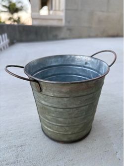 galvanized metal bucket featuring decorative side handles