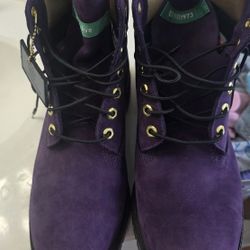 This is a pair of Timberland 6-Inch Premium "Hip Hop Royalty" boots in dark purple nubuck with gold accents. 

Worn One time... No box.. 