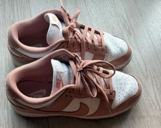 Nike Dunk Low sneakers in the "Rose Whisper" colorway, featuring a white leather base with soft pink overlays