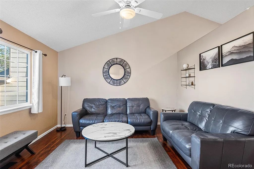Gray leather couch and loveseat with side and coffee table