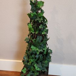Silk ivy topiary in wood container with fleur de lis on top  of metal pole