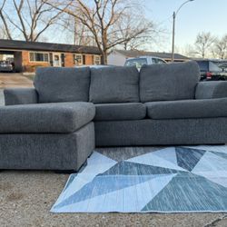 Modern gray fabric sectional with reversible chaise (can be set up left or right).