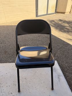 Sturdy black folding chair, ideal for events or extra seating.