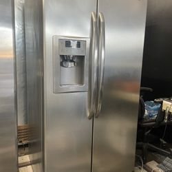 GE stainless steel side-by-side refrigerator with adjustable temperature display