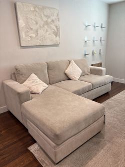 Cream/beige sectional sofa with large chaise ottoman