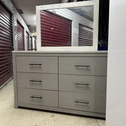 a chest of drawers with 6 drawers and its mirror