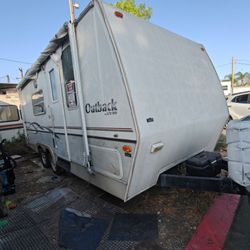2002 Outback lite travel trailer w/ pop out. Needs work . Cheap as is