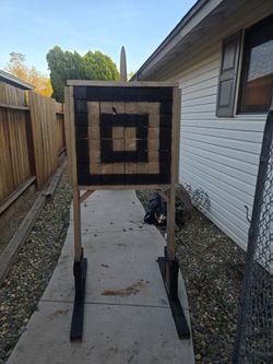 Axe throwing board with knives and axes