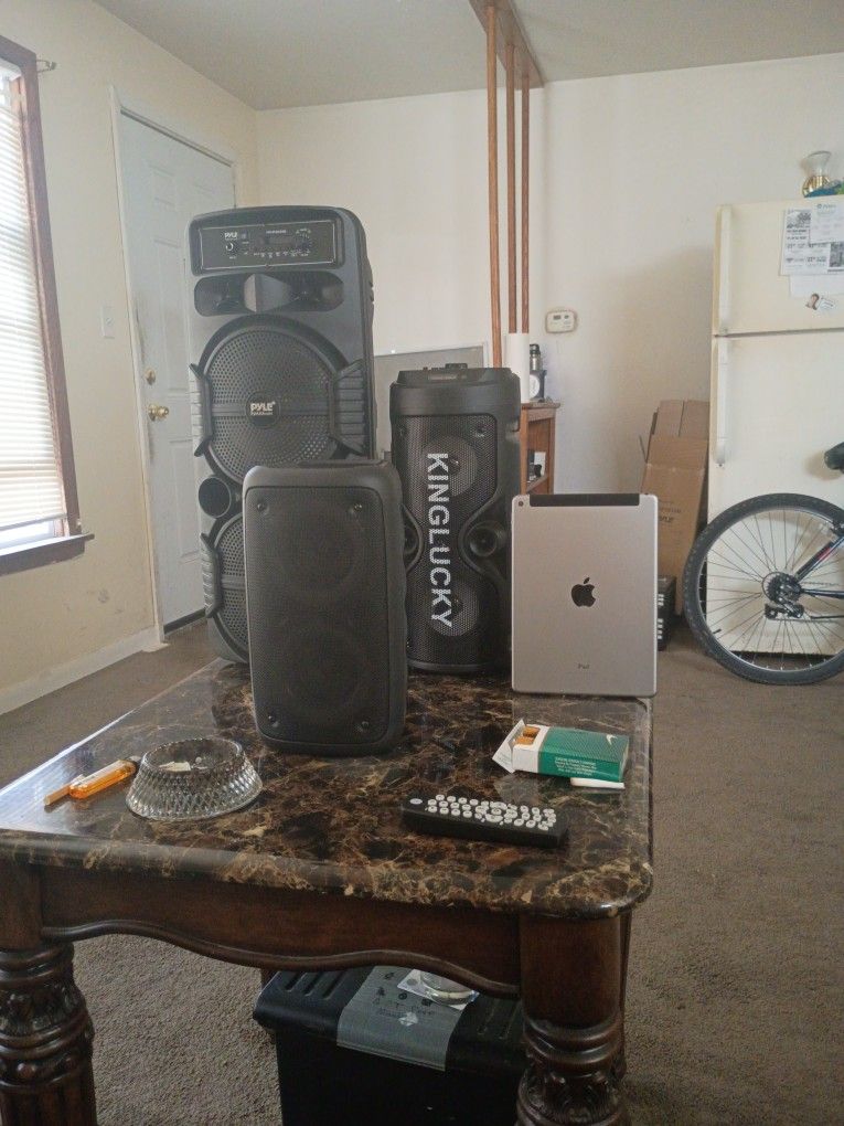 Three Bluetooth Speakers And One iPad Air 2
