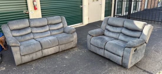 Gray sofa and loveseat with manual recliners
