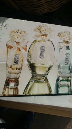 Cellini collection. 3 piece assorted crystal bottles with a touch of silver topped with a porcelain floral stoppers includes beveled mirror tray