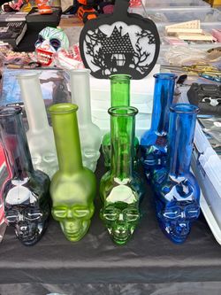 VASES striking cobalt blue glass bottle shaped like a skull with a tall, slender neck