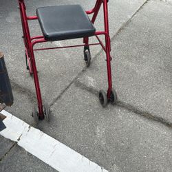 four-wheel rollator walker with a seat.