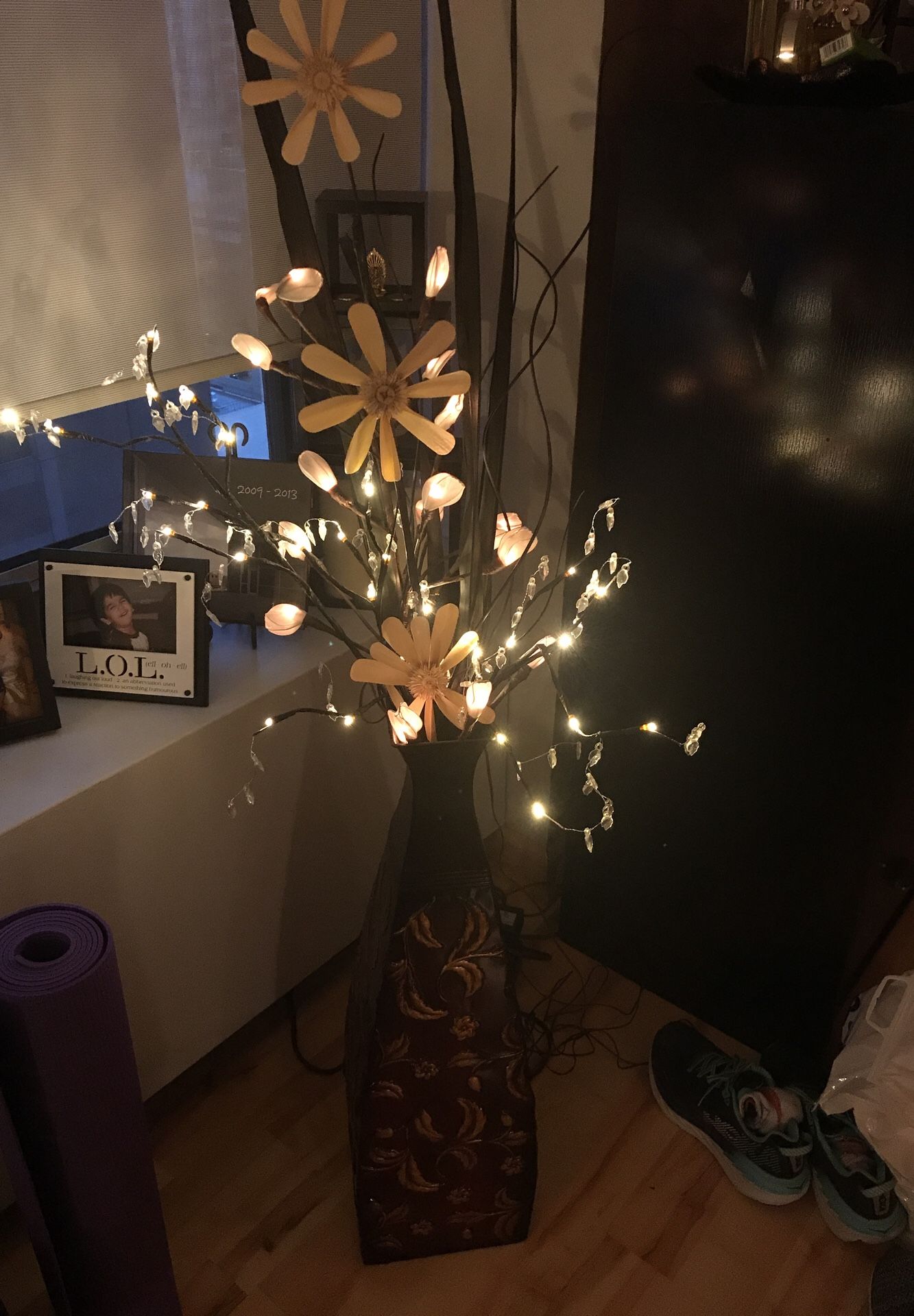 Decorative flower arrangement with lights and vase included.