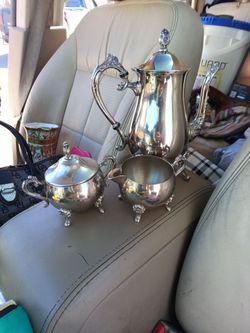 Antique silver teapot with creamer and sugar bowl