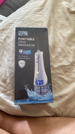 Portable oral irrigator