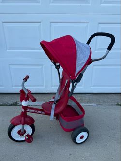 Red Radio Flyer 4-in-1 Stroll 'N Trike features a white-accented wheel design