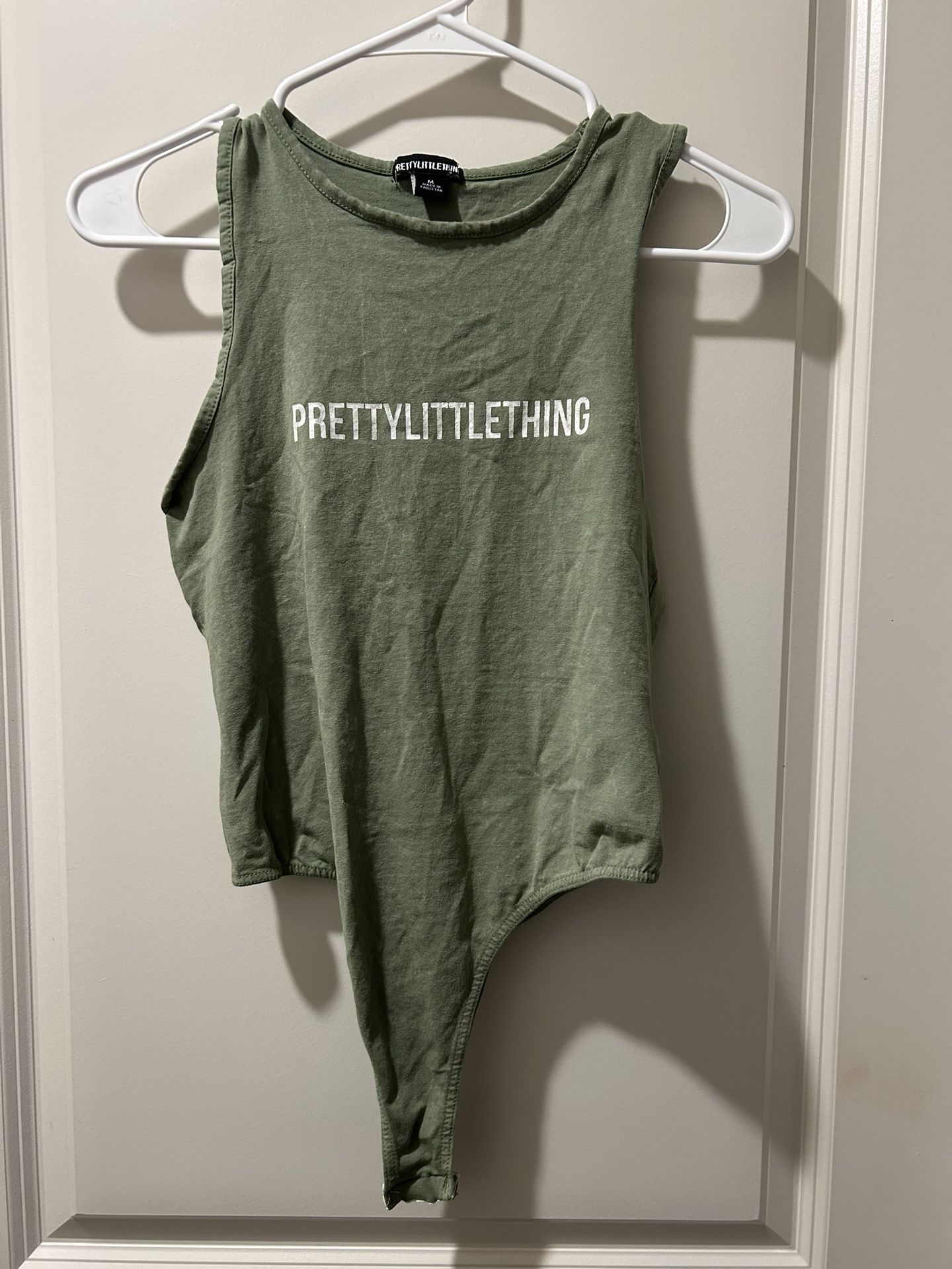 Woman’s green and white Pretty Little Things bodysuit size medium