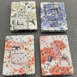 Brand new purse mirror compact.  Perfume bottle motif. 2 mirrors. 1 mirror is a magnifying mirror $8 Ea