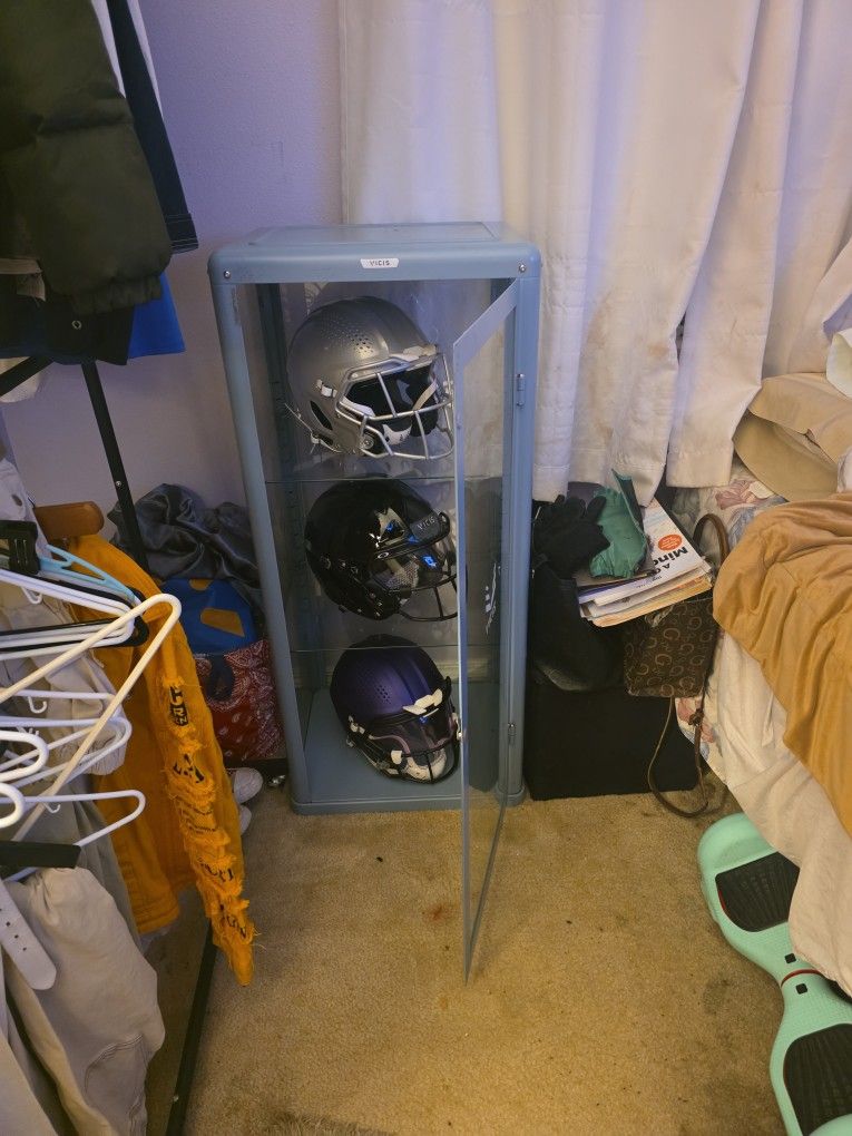 display case with professional helmets
