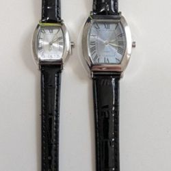 New His and hers stylish watches with black leather straps and silver dials. Both of these watches are new.
They still have the protective cover on th