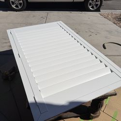 New white vinyl casement window shutters-construction left overs