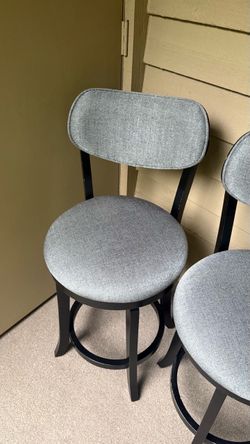 3 cushioned swivel bar stools.