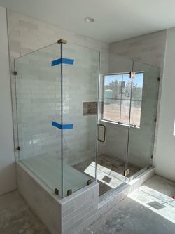 Frameless Glass Shower Enclosure with Gold Hardware