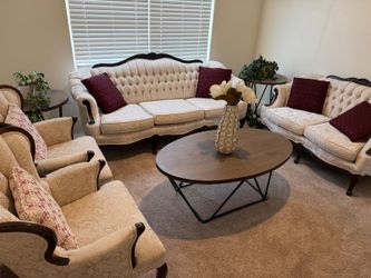 Classic cream tufted sofa, wingback armchairs, coffee table, side tables