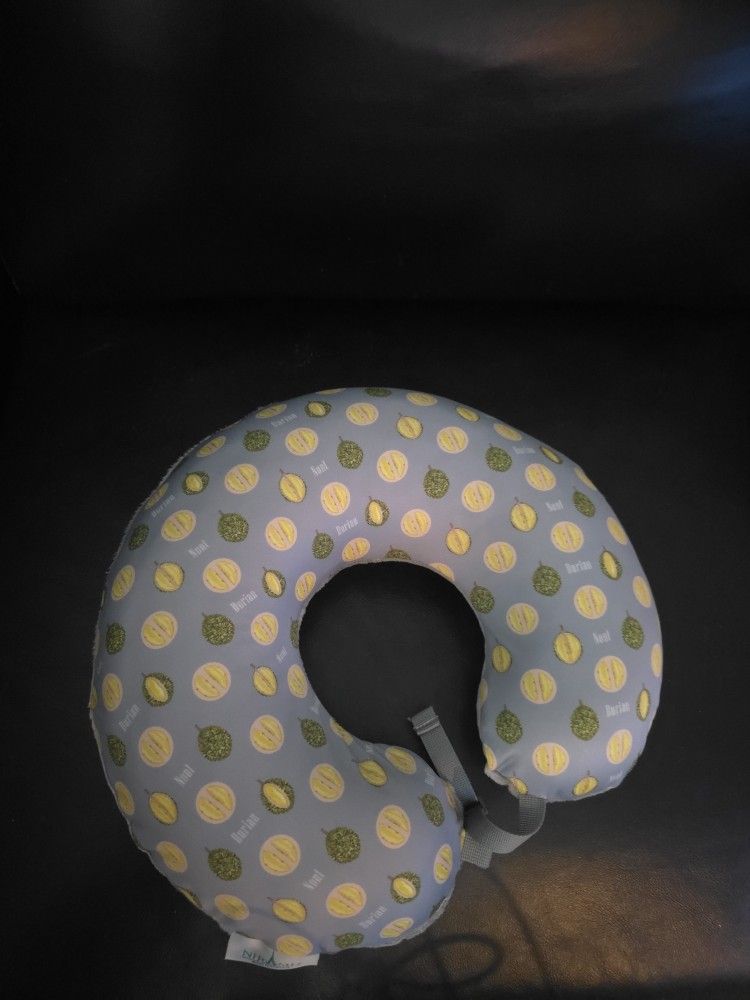 nursing pillow with a durian-patterned cover.