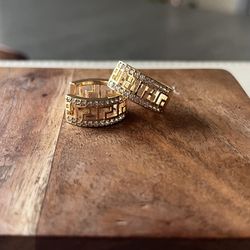 Versace style gold-plated hoop earrings with a Greek Key pattern and clear rhinestones