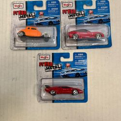 These are Maisto Fresh Metal die-cast vehicles, specifically featuring a 1934 Ford Hot Rod (orange), a red sports car similar to a Lamborghini Countac