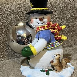 Snowman holding glass ornament figure 7” tall resin Christmas decor