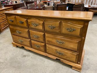 Maple Finished 9 Drawer Triple Dresser with Wave Top Drawers and Brass Swing Pulls