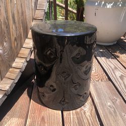 Black ceramic garden stool.
