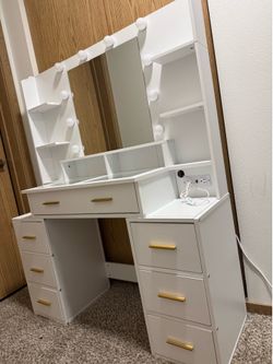 White vanity with golden handles