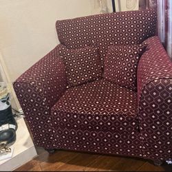 A three-seater sofa, a double seat, two single chairs, three sets of curtains, and a beautiful piece of wall art.