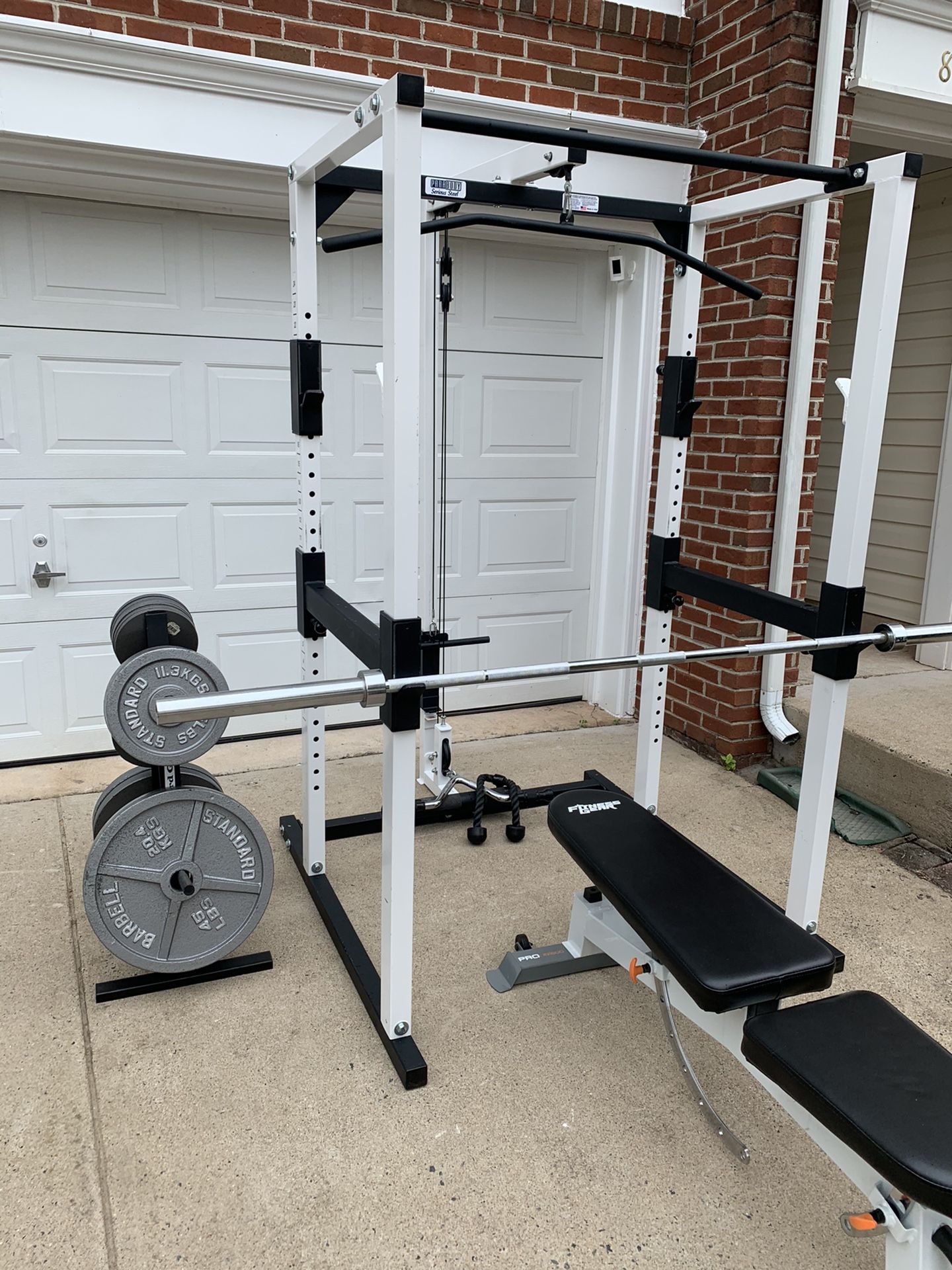 weight rack with pulley system, bench, olimpic bar, cable accessories, weight tree and 320lbs