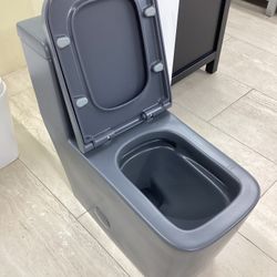 One Piece Grey Toilet New Fully Skirted With Softclose Seat Dual Flush System Square Modern Design Ready for Pick Up Today. 