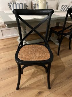 Two black dining chairs