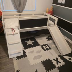 LOFT TWIN SIZED BED WITH SLIDE , LADDER ,CHALK BOARD AND MATTRESS! CUTE FOR A STARTER BED! SLIGHT DAMAGE, CRACK IN FRAME...BEST OFFER! 