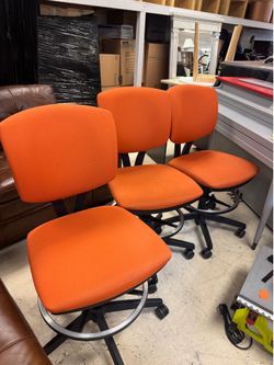 3 bright orange chairs feature durable fabric upholstery